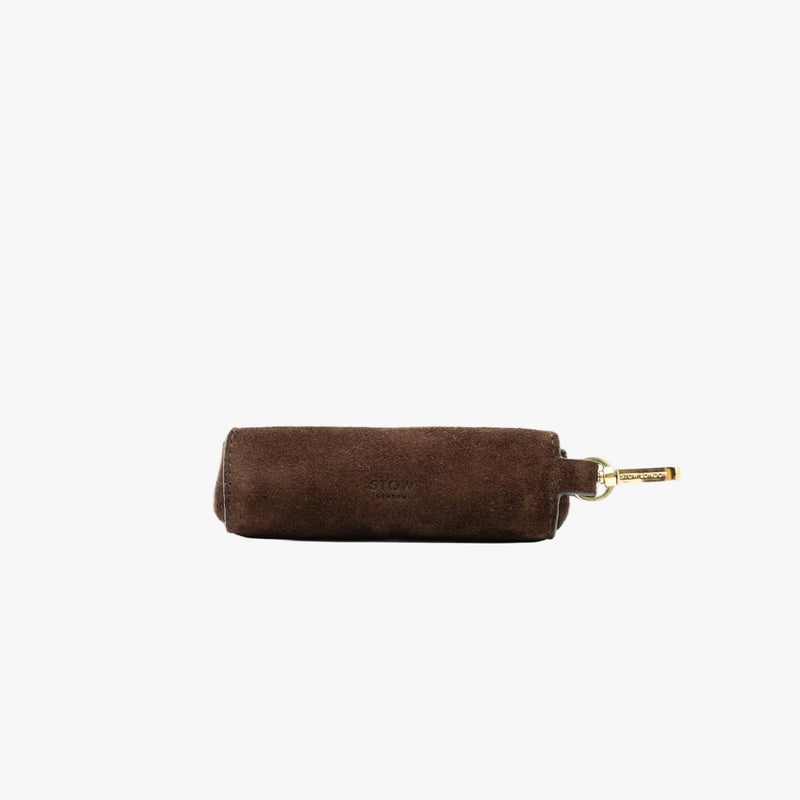 STOW London's Lipstick Case in Chocolate suede leather on a light grey background featuring a gold-coated stainless steel clip