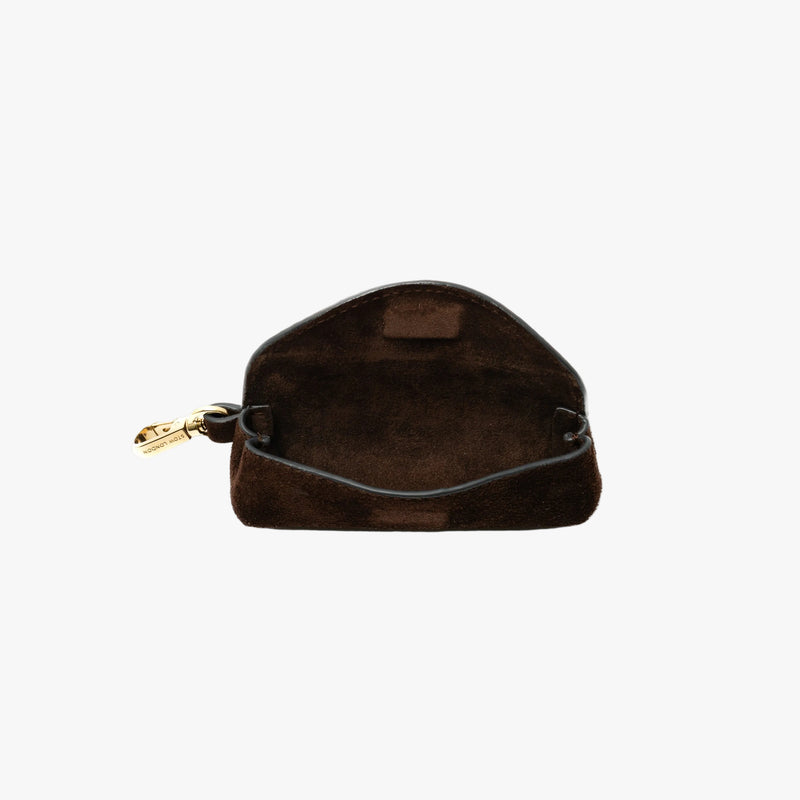 STOW London's Lipstick Case in Chocolate suede leather with flap open showing hidden magnetic closure and suede interior on a light grey background featuring a gold-coated stainless steel clip