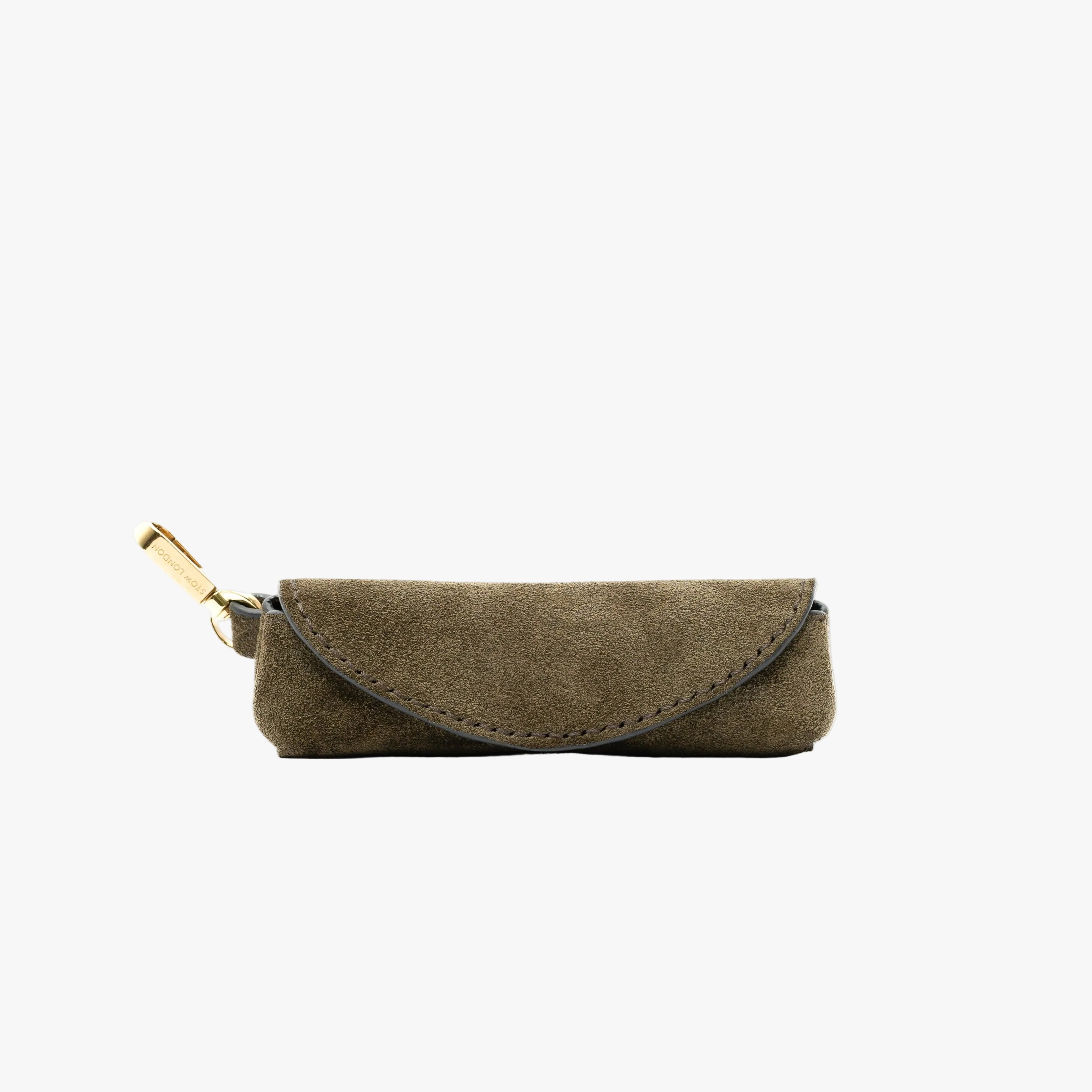STOW London's Lipstick Case in Dark Green suede leather on a light grey background featuring a gold-coated stainless steel clip