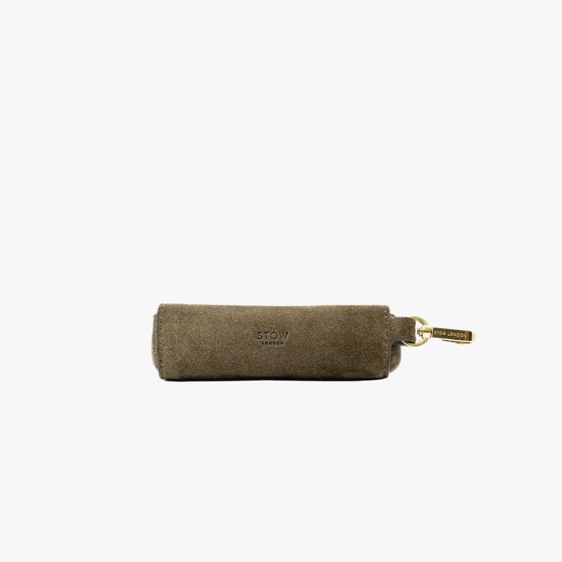 STOW London's Lipstick Case in Dark Green suede leather on a light grey background featuring a gold-coated stainless steel clip