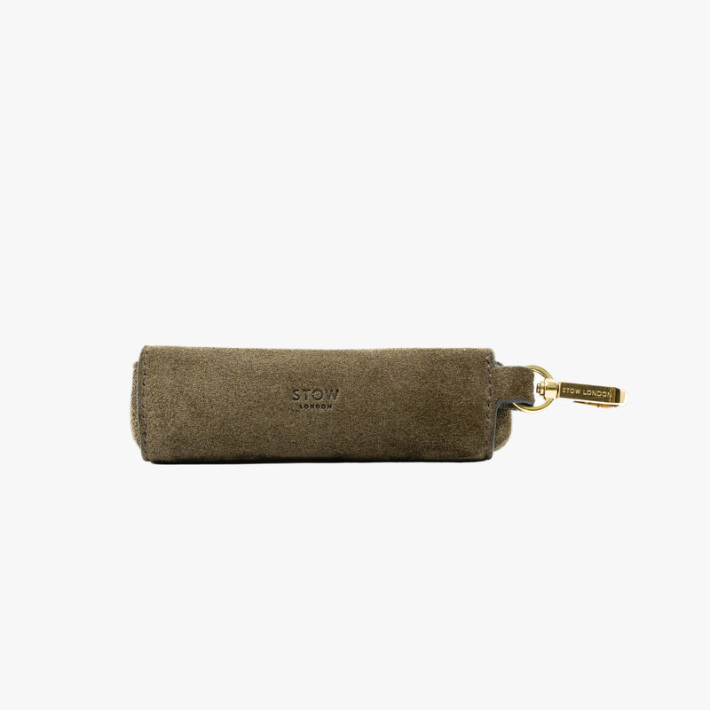 STOW London's Lipstick Case in Dark Green suede leather on a light grey background featuring a gold-coated stainless steel clip