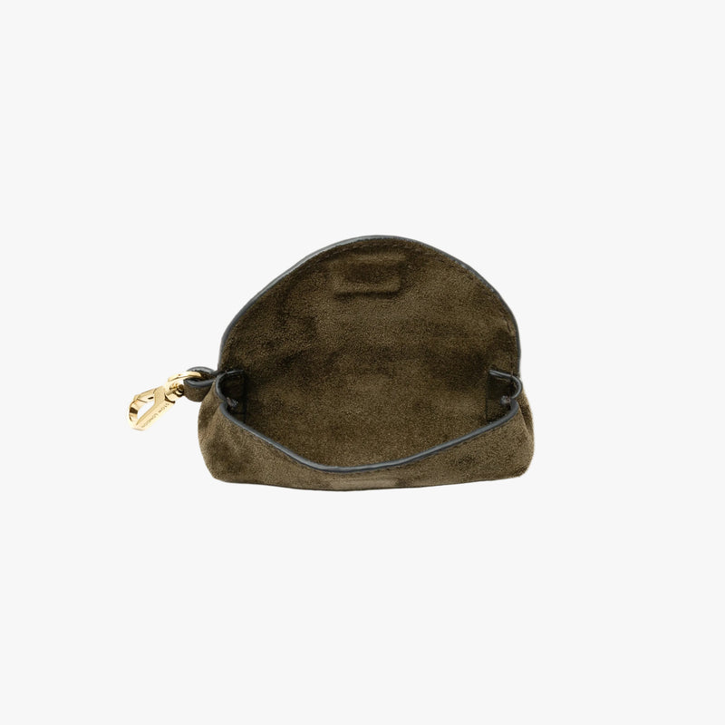 STOW London's Lipstick Case in Dark Green suede leather with flap open showing hidden magnetic closure and suede interior on a light grey background featuring a gold-coated stainless steel clip