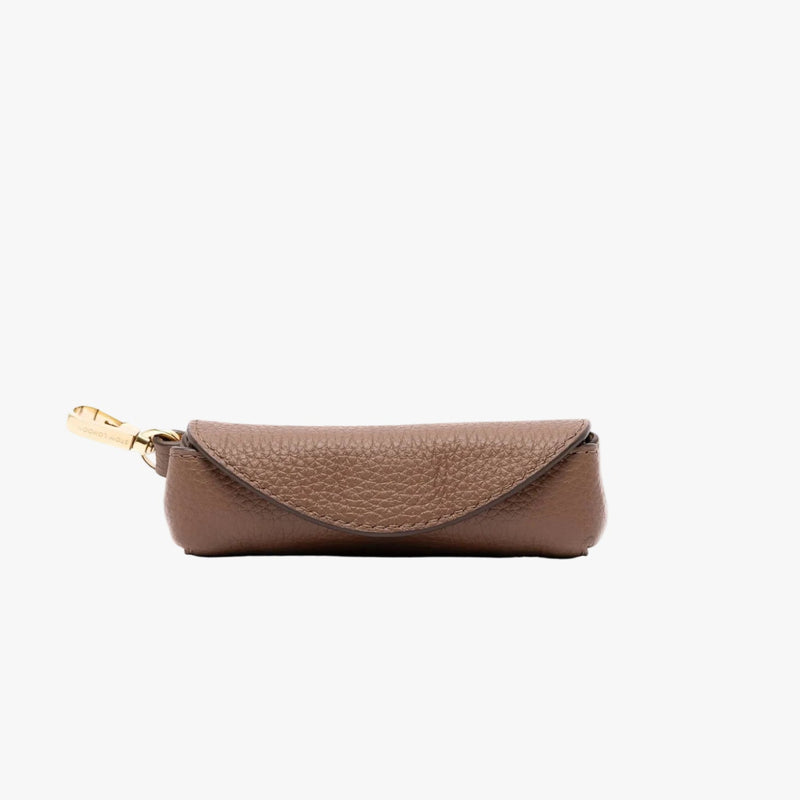 STOW London's Lipstick Case in Mocha pebbled leather on a light grey background featuring gold-coated stainless steel hardware