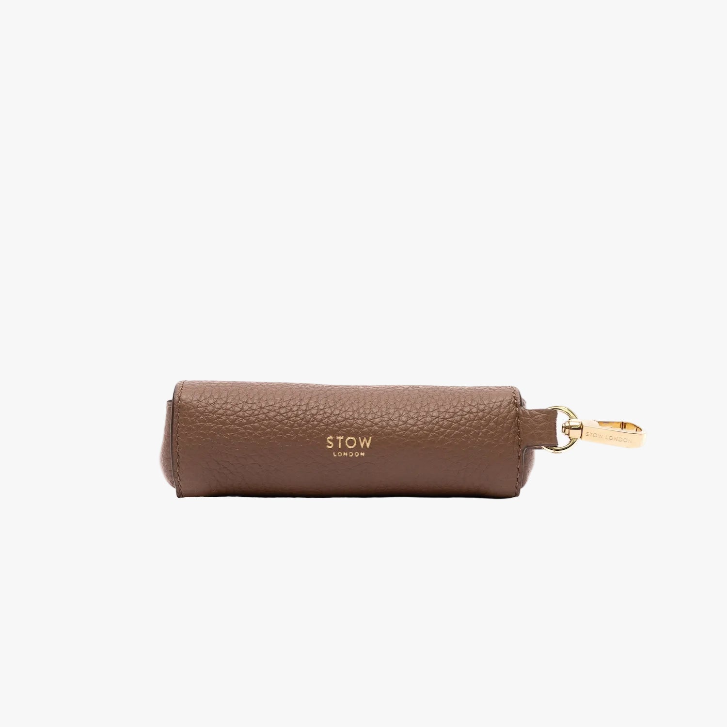 STOW London's Lipstick Case in Mocha pebbled leather on a light grey background featuring gold-coated stainless steel hardware and embossed logo