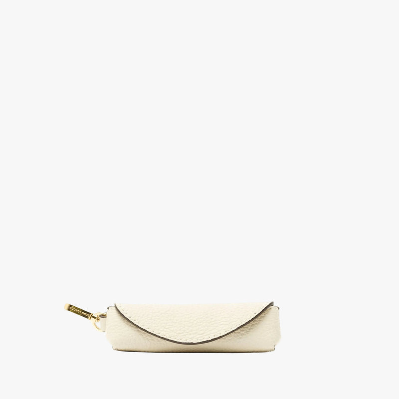 STOW London's Lipstick Case in Spring Moon pebbled leather featuring a gold-coated stainless steel clip on a light grey background