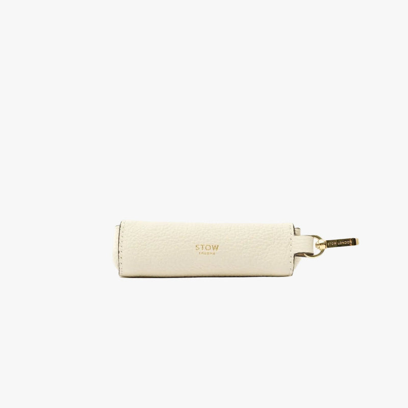 STOW London's Lipstick Case in Spring Moon pebbled leather featuring a gold-coated stainless steel clip and gold logo on a light grey background