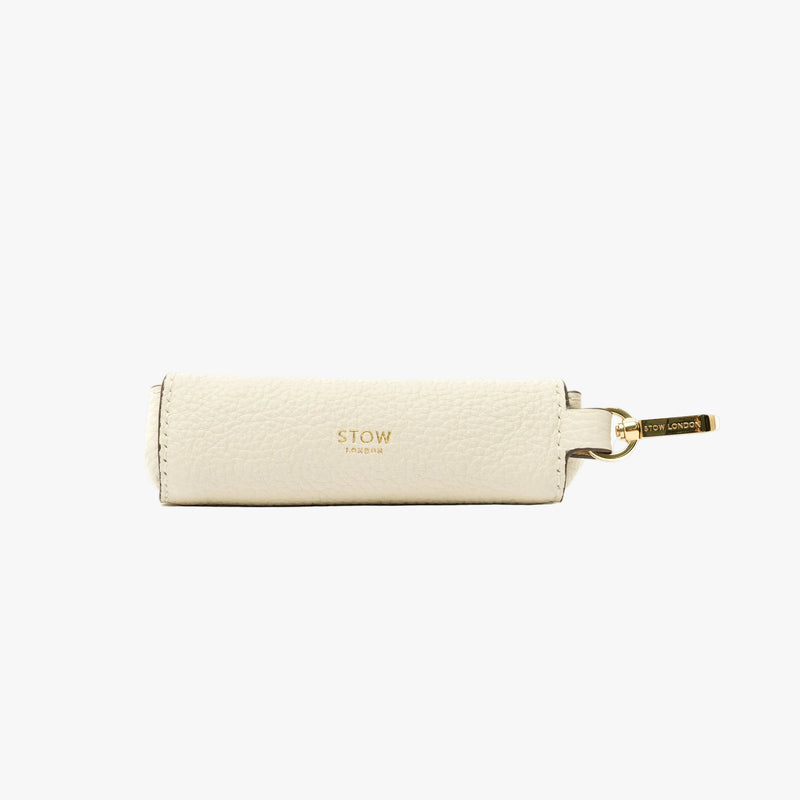 STOW London's Lipstick Case in Spring Moon pebbled leather featuring a gold-coated stainless steel clip and gold logo on a light grey background