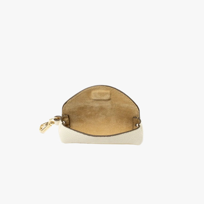 STOW London's Lipstick Case in Spring Moon pebbled leather with flap open showing the hidden magnetic closure and suede interior lining featuring a gold-coated stainless steel clip on a light grey background