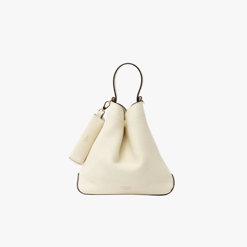 STOW London's Lipstick Case in Spring Moon pebbled leather featuring a gold-coated stainless steel clip on a light grey background