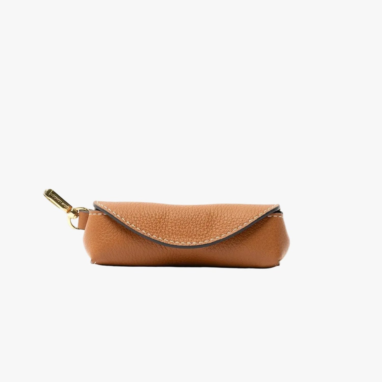 STOW London's Lipstick Case in Earth Tan pebbled leather featuring a gold-coated stainless steel clip on a light grey background