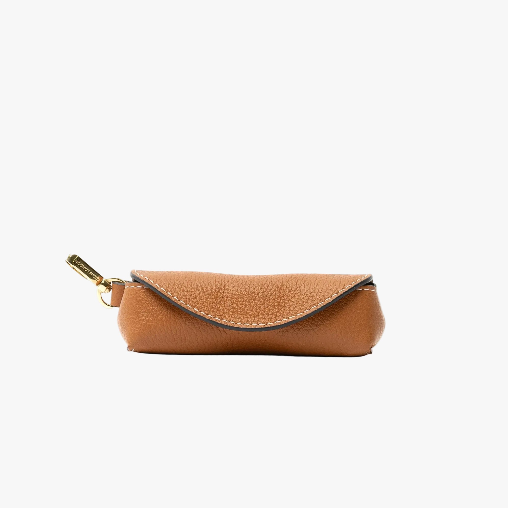 STOW London's Lipstick Case in Earth Tan pebbled leather featuring a gold-coated stainless steel clip on a light grey background