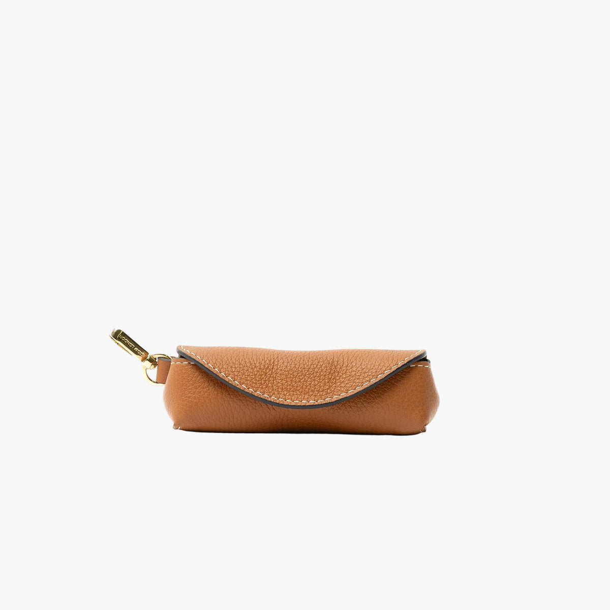 STOW London's Lipstick Case in Earth Tan pebbled leather featuring a gold-coated stainless steel clip on a light grey background