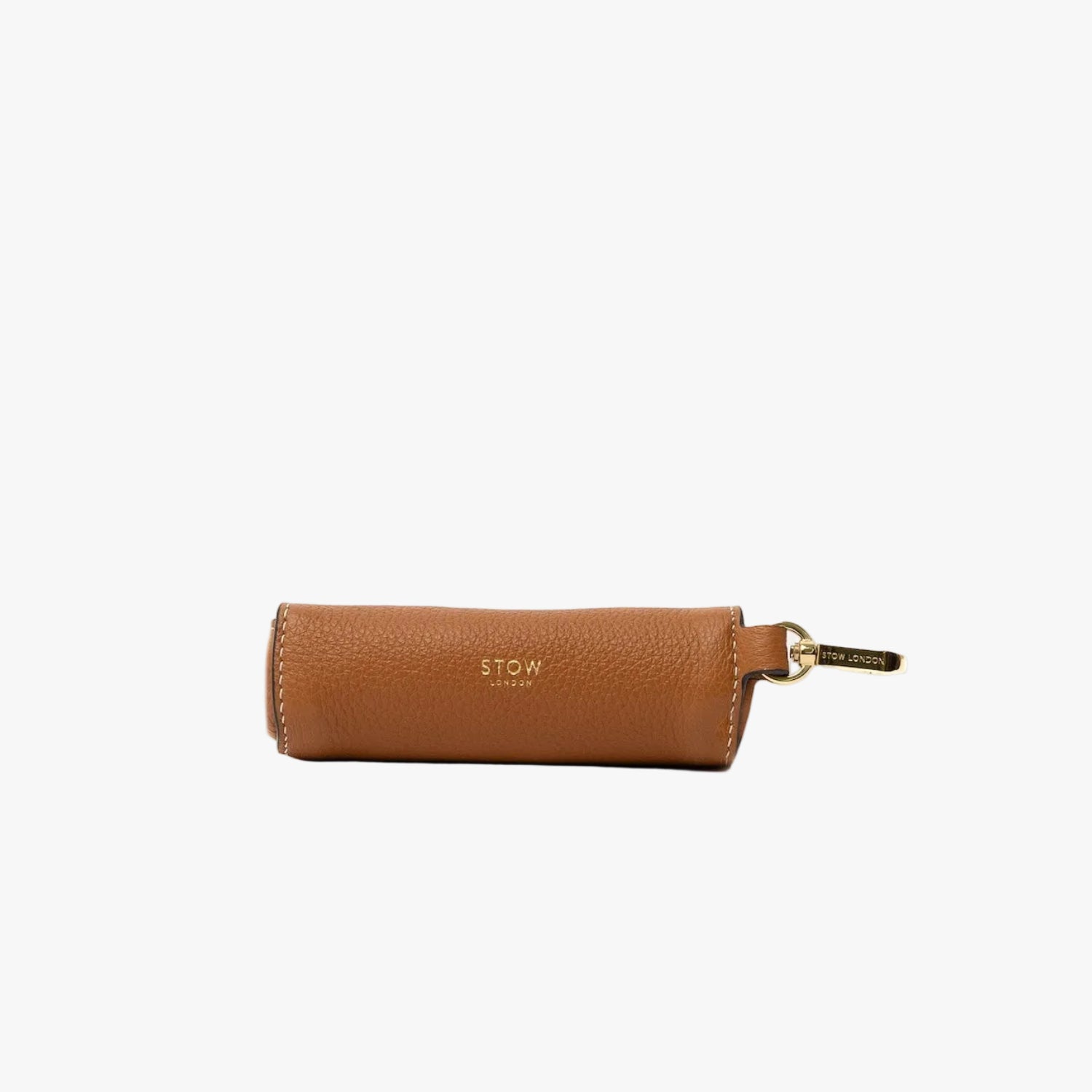 STOW London's Lipstick Case in Earth Tan pebbled leather on a light grey background featuring gold-coated stainless steel hardware