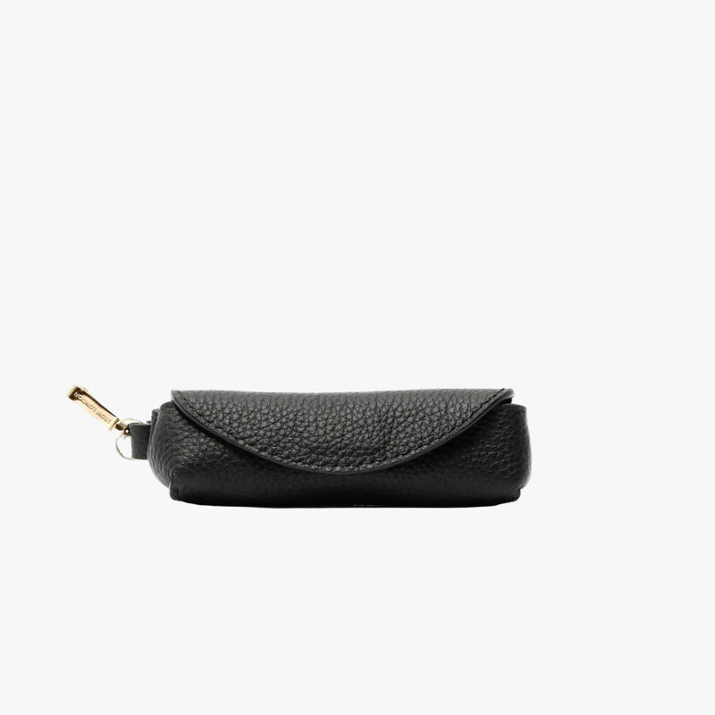 STOW London's Lipstick Case in Black pebbled leather featuring a gold-coated stainless steel clip on a light grey background