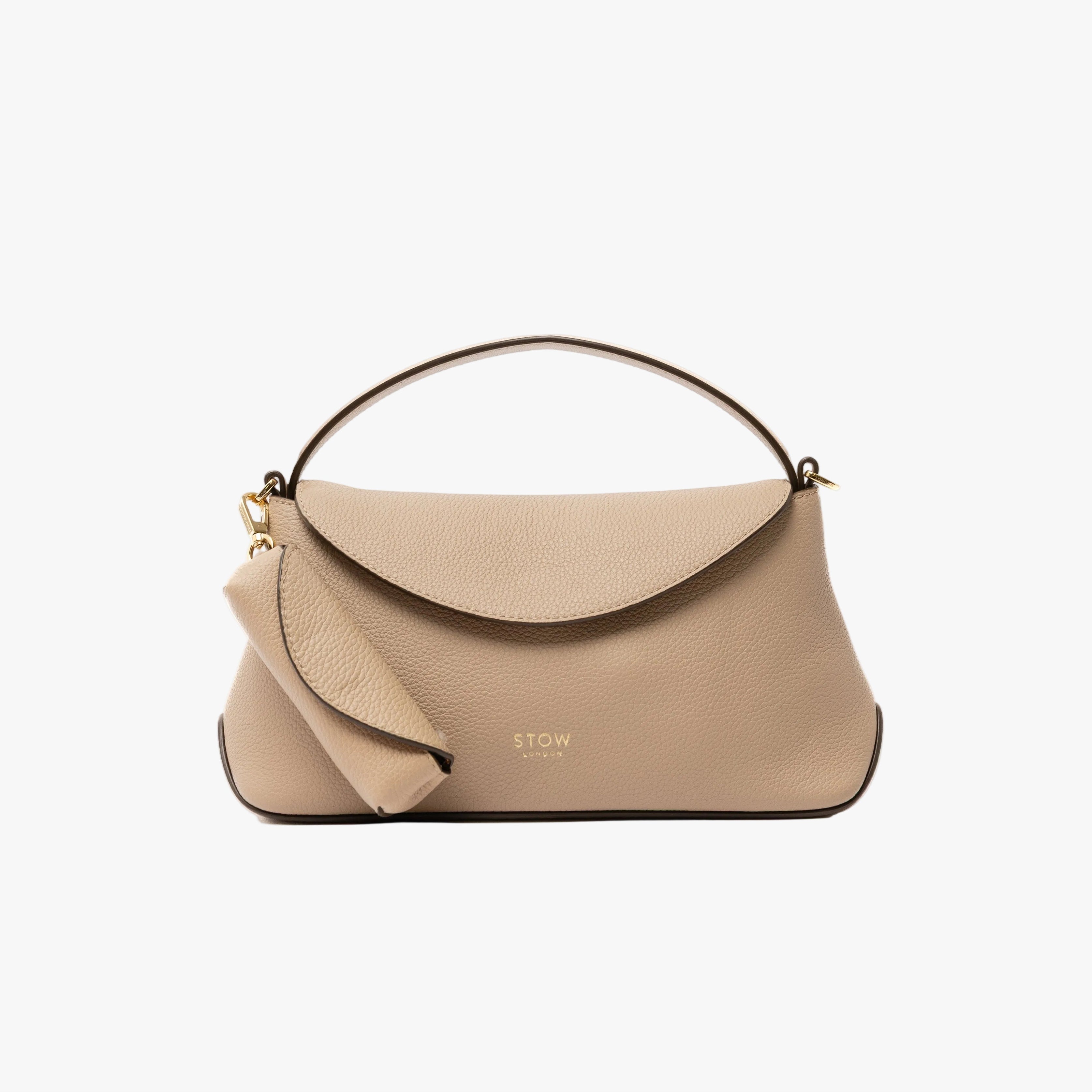 STOW London's Lipstick Case in Camel pebbled leather attached by a gold-coated stainless steel clip to the matching Mini East West Bag on a light grey background