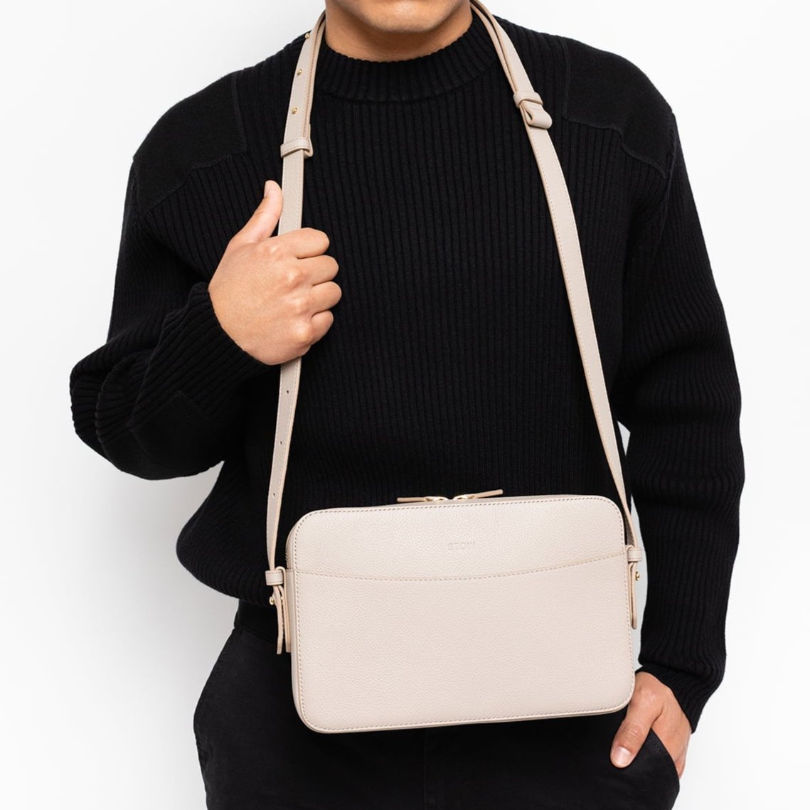 STOW London Large Camera Bag in Light Taupe leather worn by male model wearing black in studio