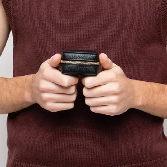 STOW London Mini Essentials Case in Black leather held in hands of male model in studio