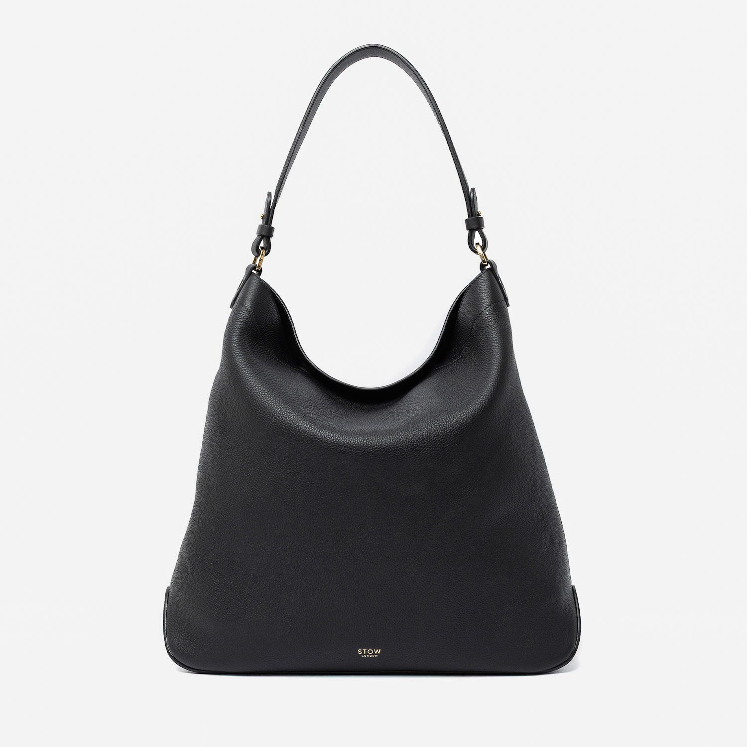 STOW London's Maxi Curve bag in Black pebbled leather featuring gold-coated stainless steel hardware on a light grey background