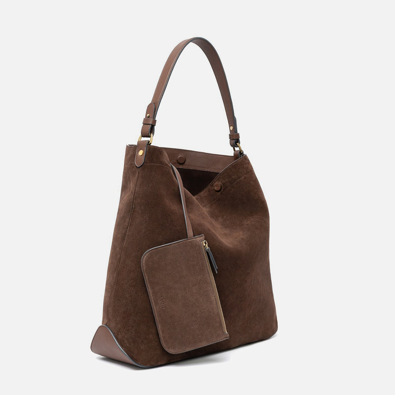 Off-axis view of STOW London's Maxi Curve bag in Chocolate suede leather and matching, detachable interior pouch featuring gold-coated stainless steel hardware on a light grey background