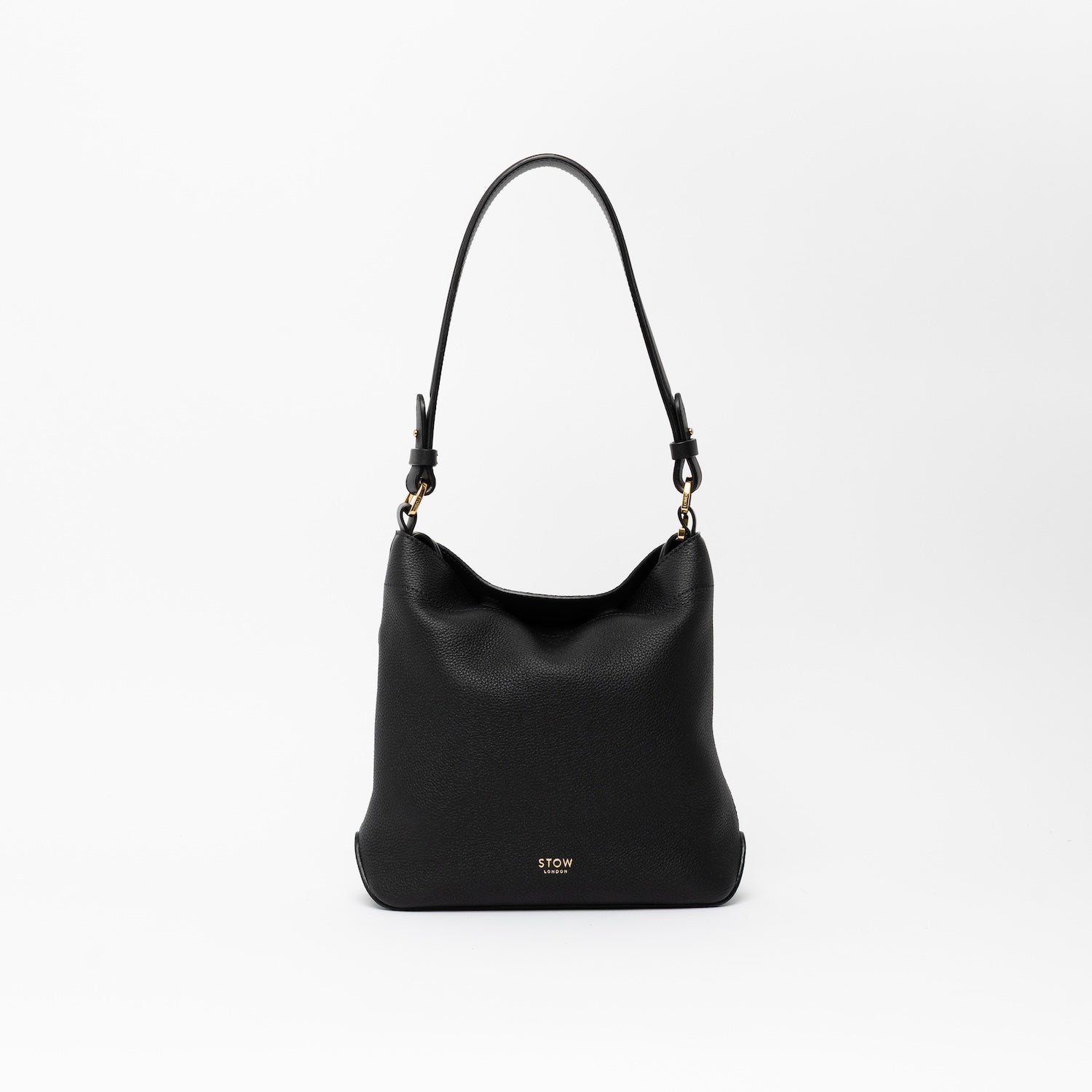 STOW London's Midi Curve and detachable shoulder strap in Black leather on a light grey background featuring gold hardware and details 