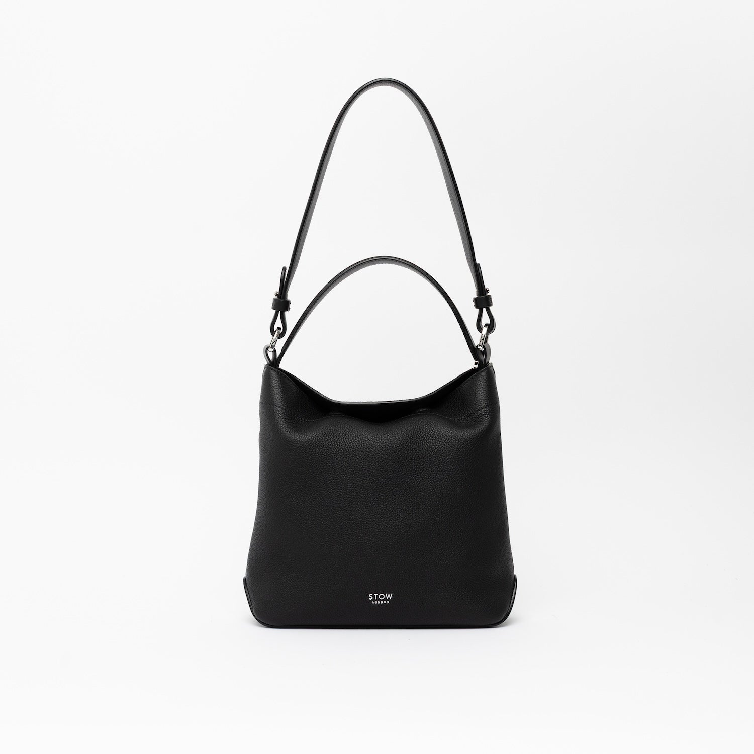STOW London's Midi Curve and detachable shoulder strap and top handle in Black leather on a light grey background featuring silver hardware and details 