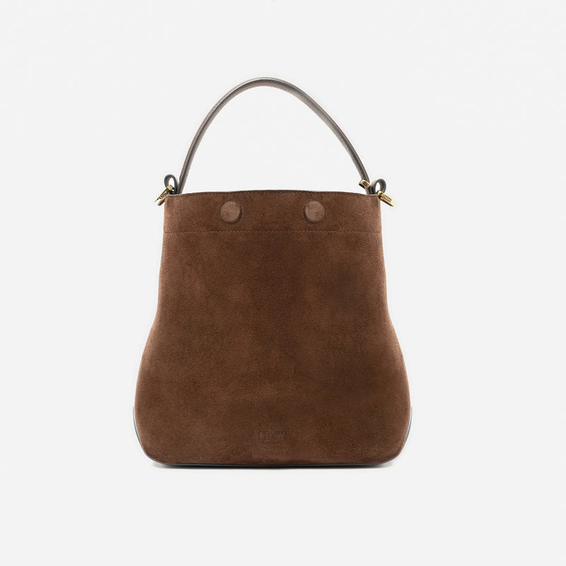 STOW London's Midi Curve in Chocolate suede leather styled as a bucket bag featuring gold-coated stainless steel hardware on a light grey background