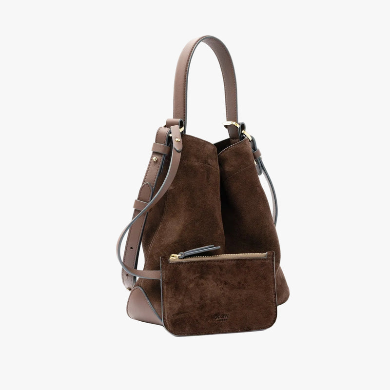 STOW London's Midi Curve in Chocolate suede leather and matching, detachable zip pouch featuring gold-coated stainless steel hardware on a light grey background