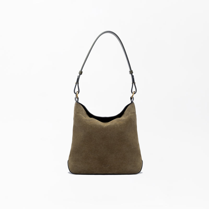 STOW London's Midi Curve in Dark Green suede leather on a light grey background featuring the detachable shoulder strap with gold hardware and details 