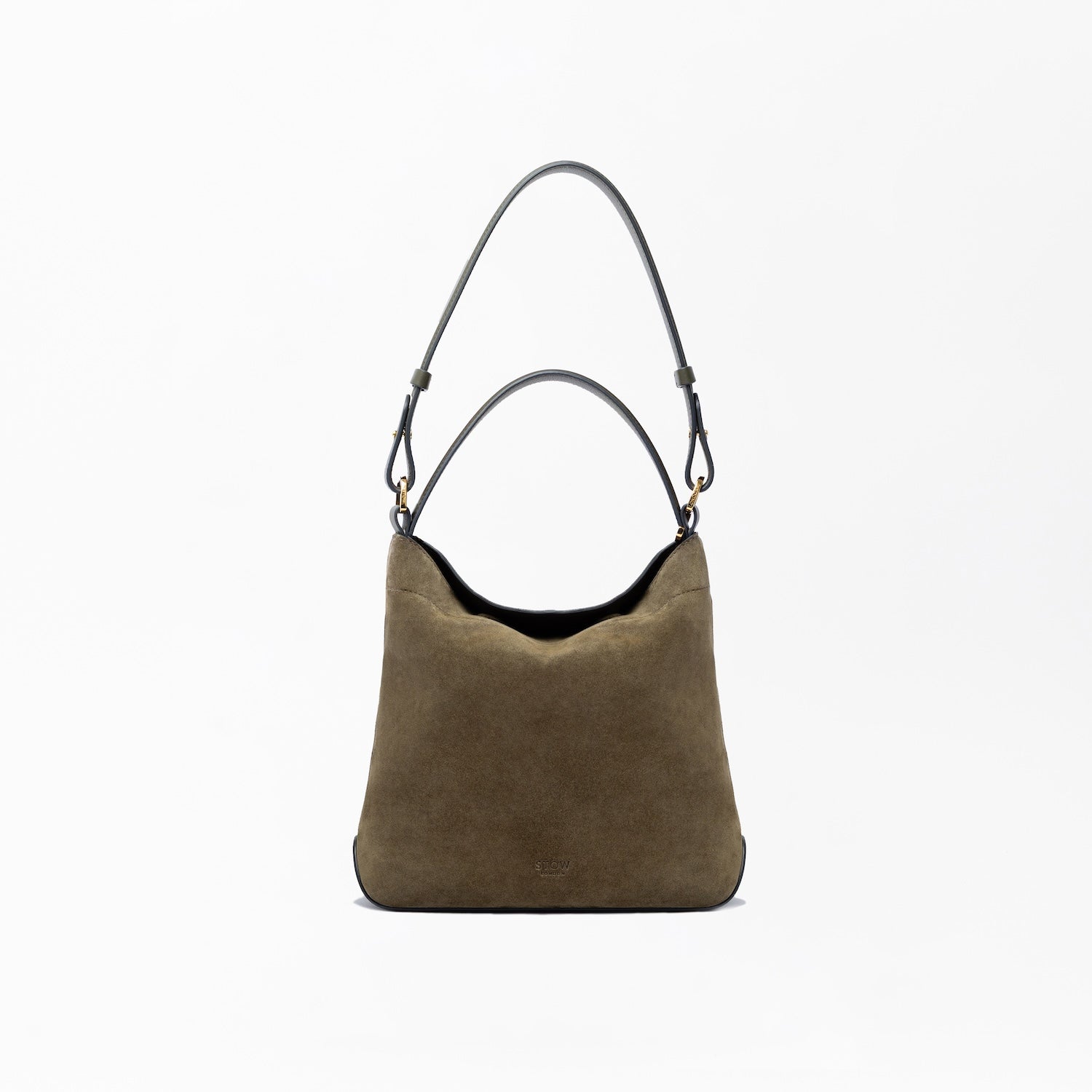 STOW London's Midi Curve in Dark Green suede leather on a light grey background featuring the detachable shoulder strap and top handle with gold hardware and details 