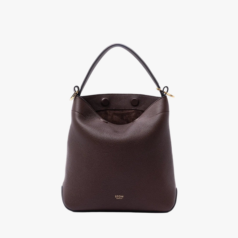 STOW London's Midi Curve in Espresso pebbled leather with magnets open showing the chocolate suede interior lining featuring gold-coated stainless steel hardware on a light grey background