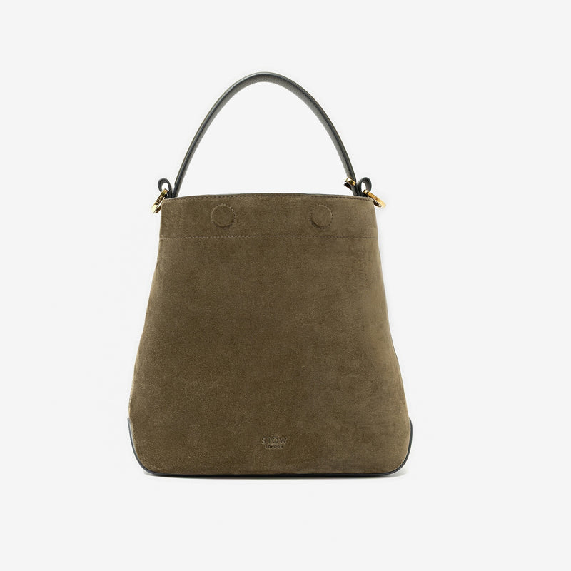 STOW London's Midi Curve in Dark Green suede leather styled a bucket bag featuring gold-coated stainless steel hardware on a light grey background