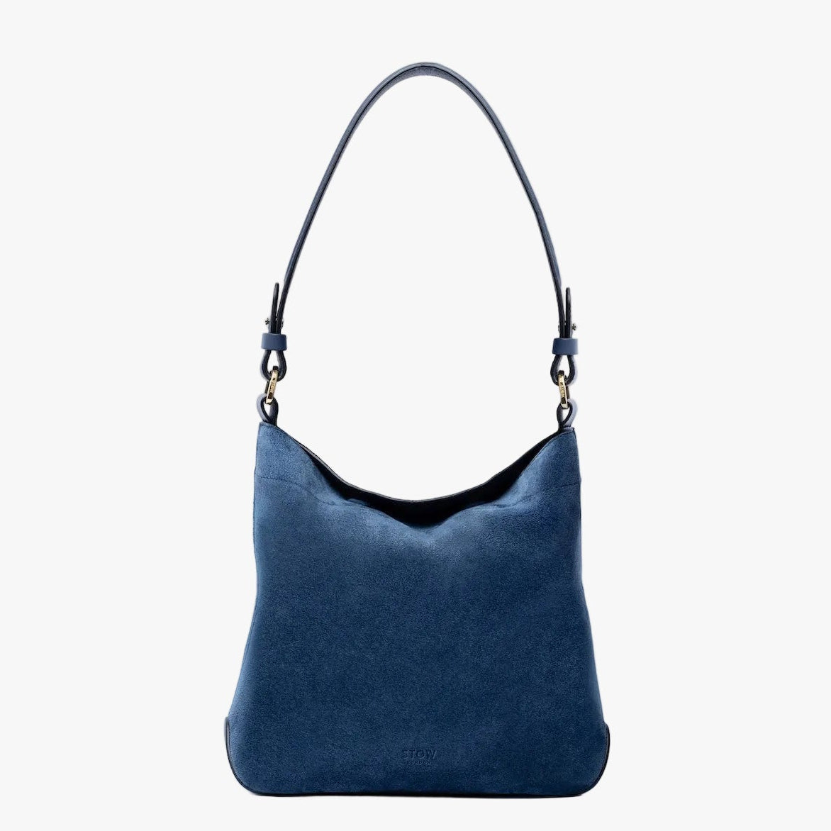 STOW London's Midi Curve in Navy suede leather on a light grey background featuring the detachable shoulder strap with gold hardware and details 