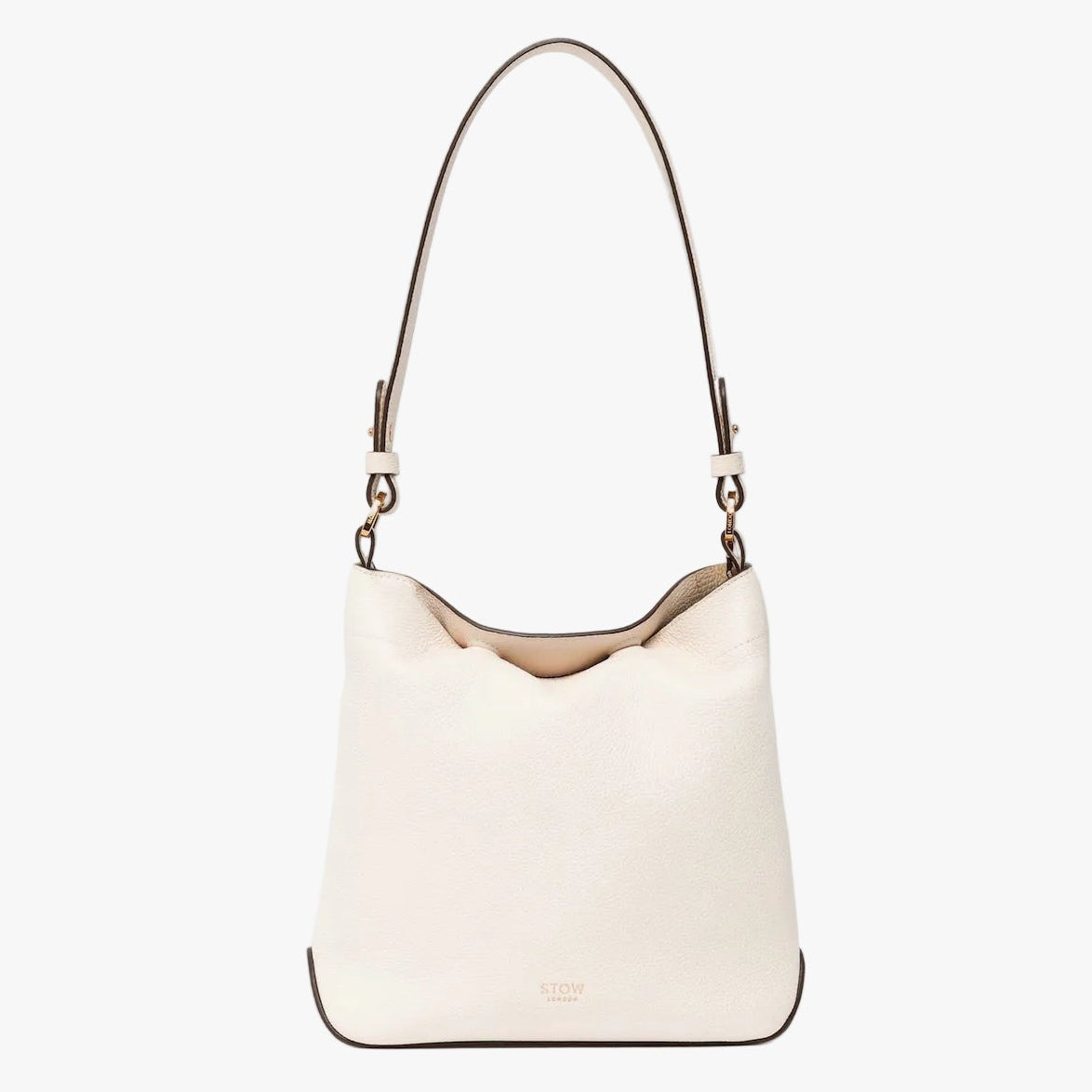 STOW London's Midi Curve in Spring Moon leather with top handle tucked inside the bag on a light grey background featuring the detachable shoulder strap with gold hardware and details 