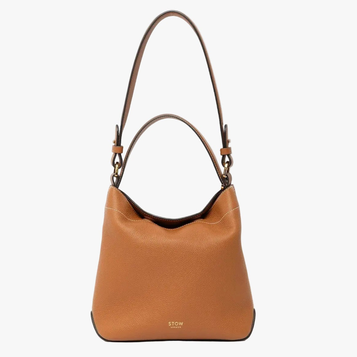 STOW London's Midi Curve in Earth Tan leather with the detachable shoulder strap with top handle out on a light grey background featuring gold details 