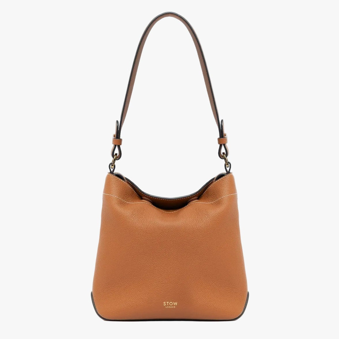 STOW London's Midi Curve in Earth Tan leather with the detachable shoulder strap on a light grey background featuring gold details 