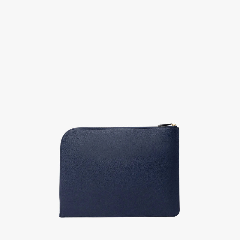 Back panel of STOW London's Midi Leather Sleeve in Navy pebbled leather on a light grey background featuring a YKK Natulon Zip 
