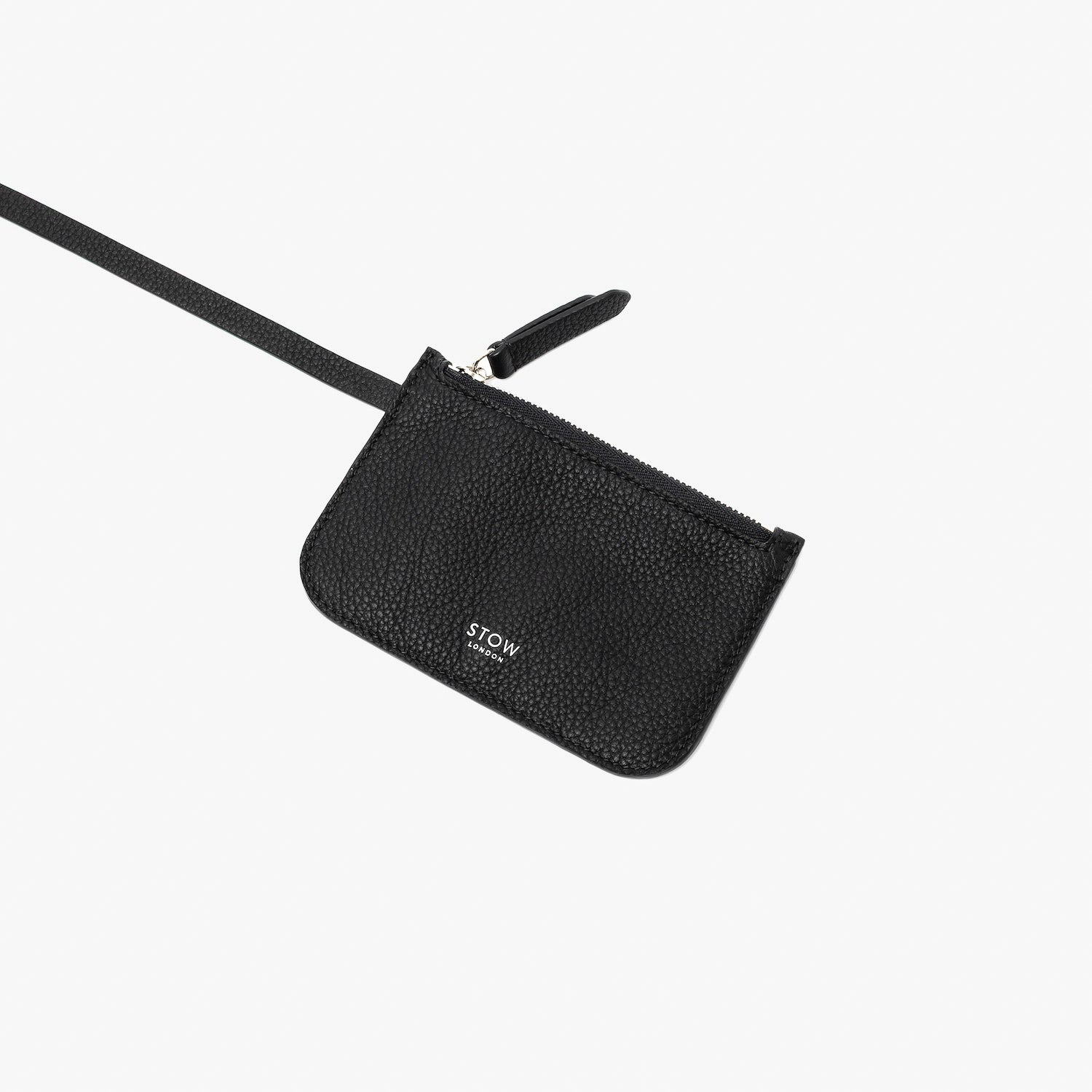 Close up of the detachable interior pouch from STOW London's Midi Curve in Black pebbled leather on a light grey background