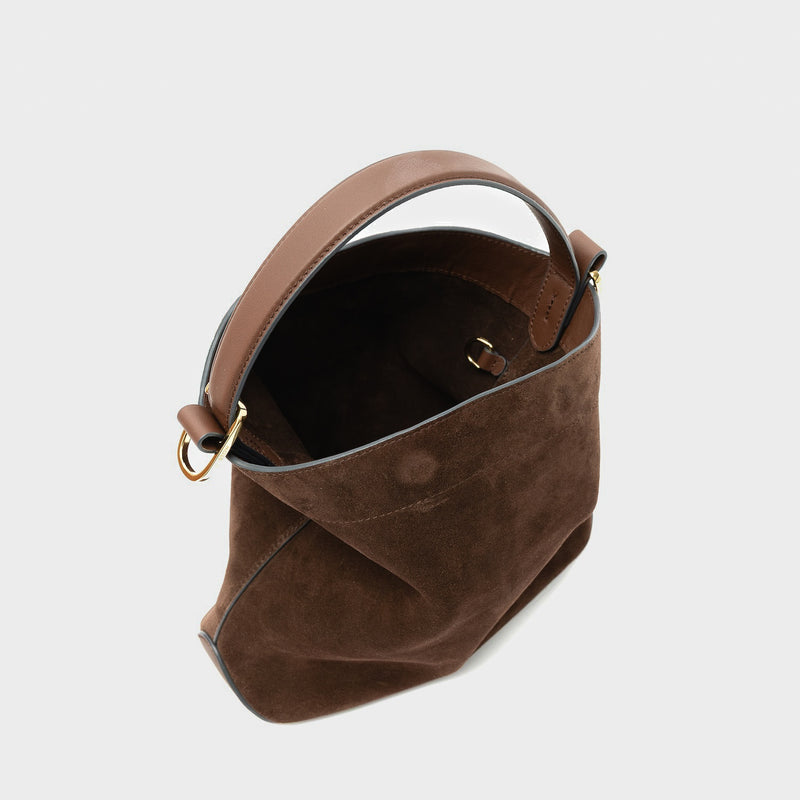 STOW London's Midi Curve in Chocolate suede leather with magnets open showing the suede interior and d-ring featuring gold-coated stainless steel hardware on a light grey background