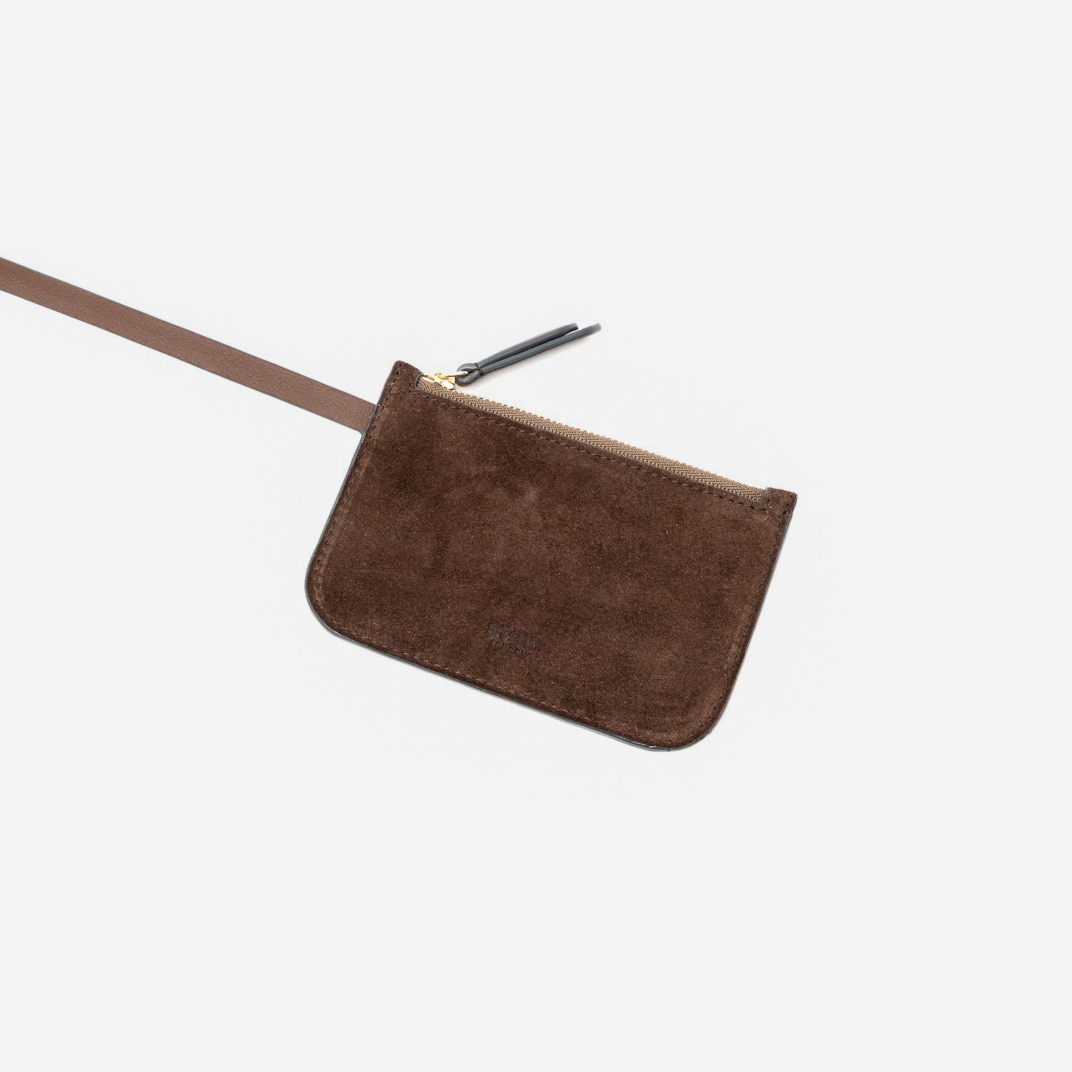 Close up of the detachable interior pouch of STOW London's Midi Curve in Chocolate suede leather on a light grey background