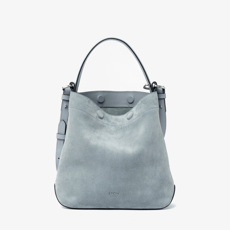 STOW London's Midi Curve in Misty Blue suede leather featuring silver stainless steel hardware on a light grey background