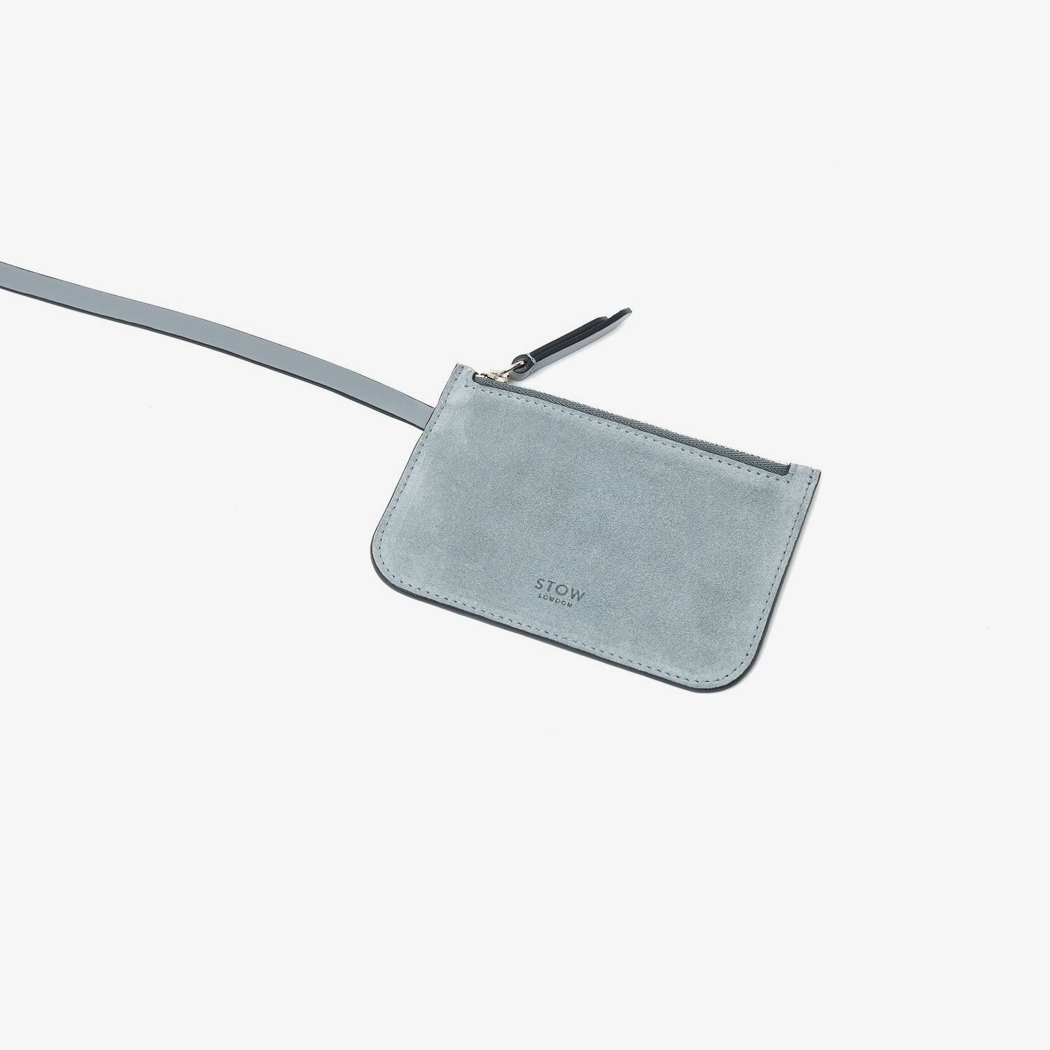 Close up of the detachable interior pouch of STOW London's Midi Curve in Misty Blue suede leather featuring on a light grey background