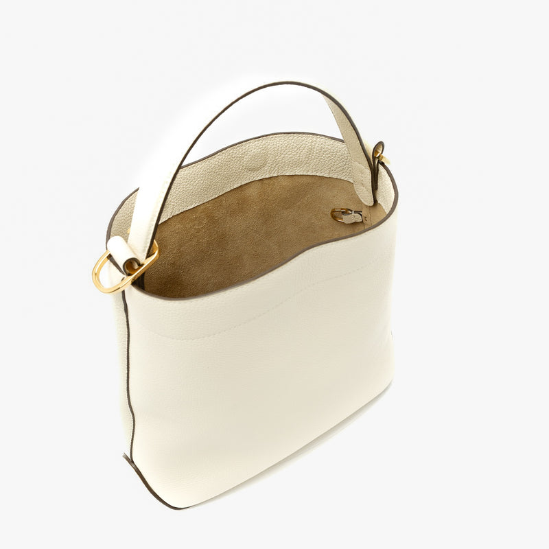 STOW London's Midi Curve in Spring Moon pebbled leather with magnets open showing light beige suede and d-ring featuring gold-coated stainless steel hardware on a light grey background