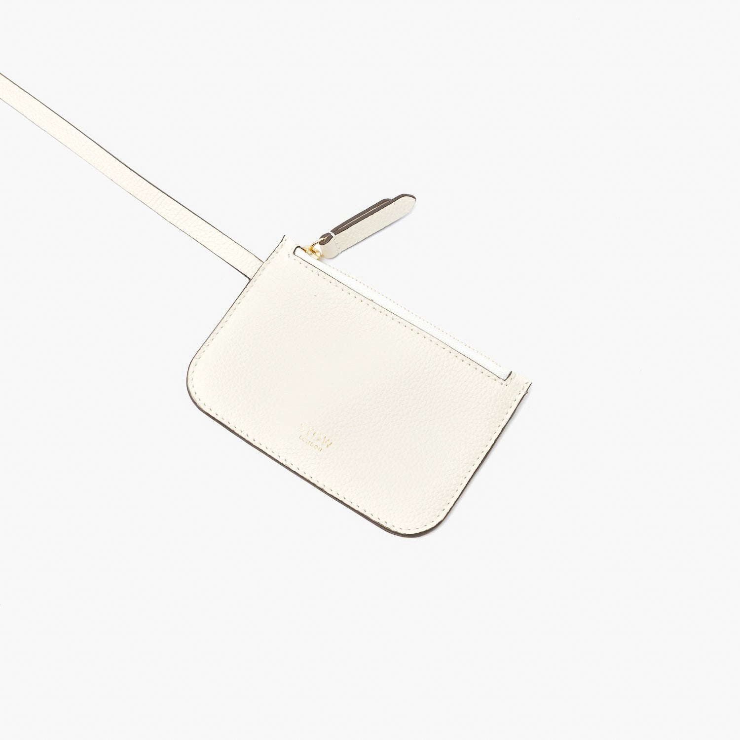 Close up of the detachable interior pouch from STOW London's Midi Curve in Spring Moon pebbled leather featuring gold-coated stainless steel hardware on a light grey background