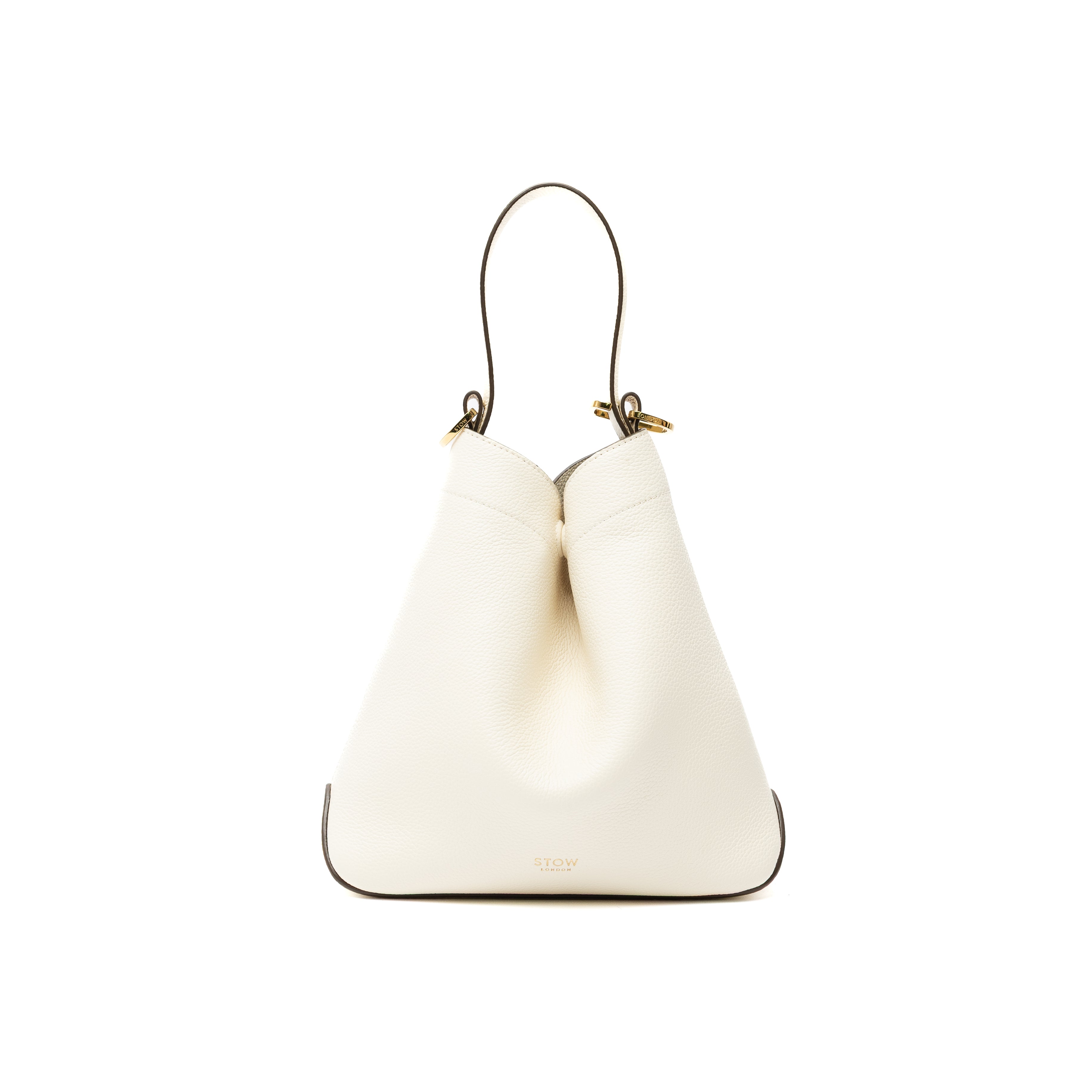 STOW London's Midi Curve bag in Spring Moon pebbled and smooth leather styled in the triangular shape featuring gold-coated stainless steel hardware on a white background
