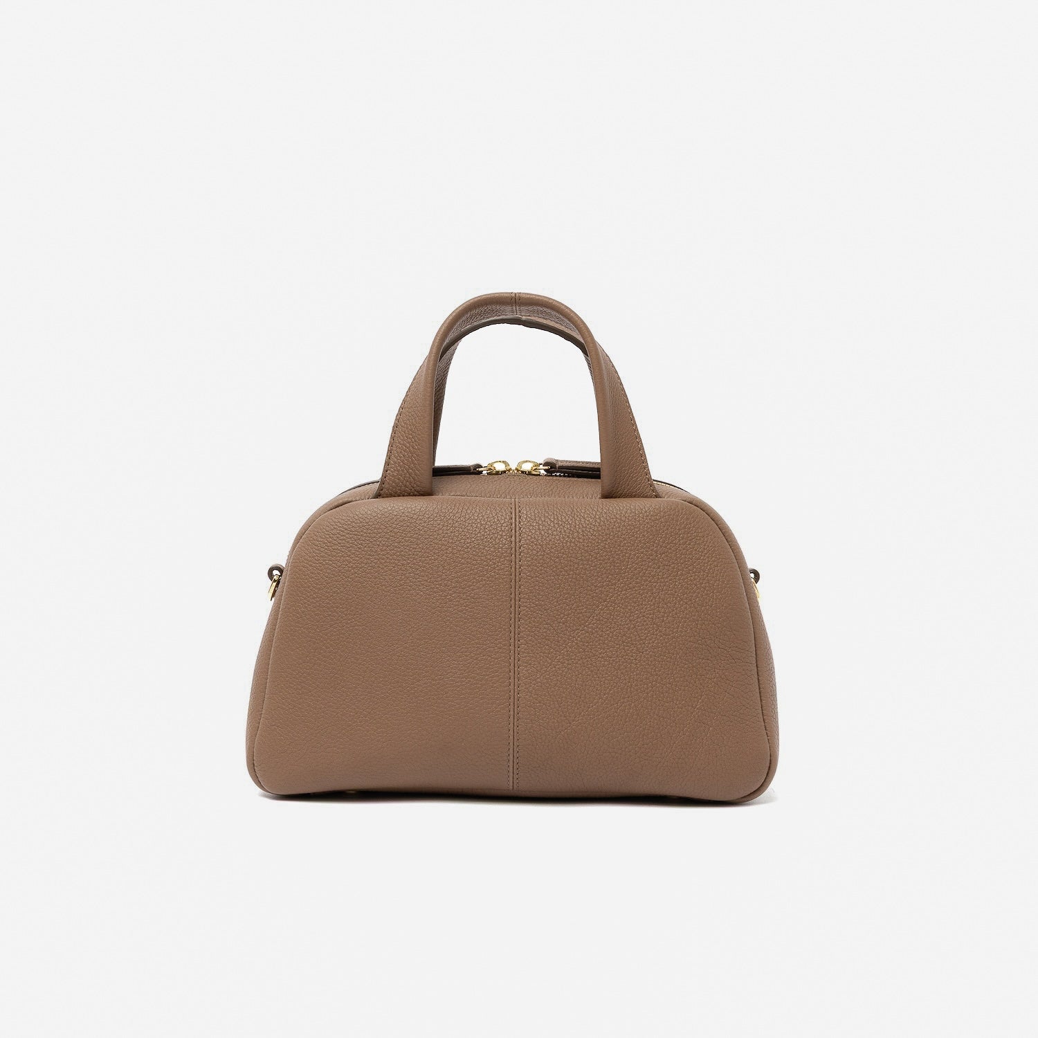 Back panel of STOW London's Mini Bowling bag in Mocha pebbled leather featuring gold-coated stainless steel hardware on a light grey background