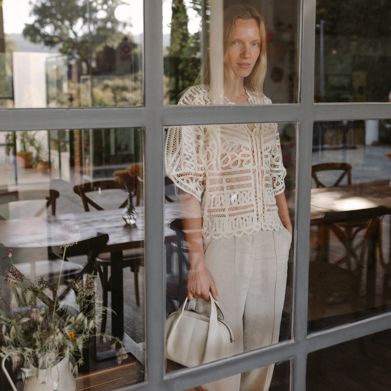 Model with STOW London's Midi Bowling  in Spring Moon pebbled leather featuring gold-coated stainless steel hardware