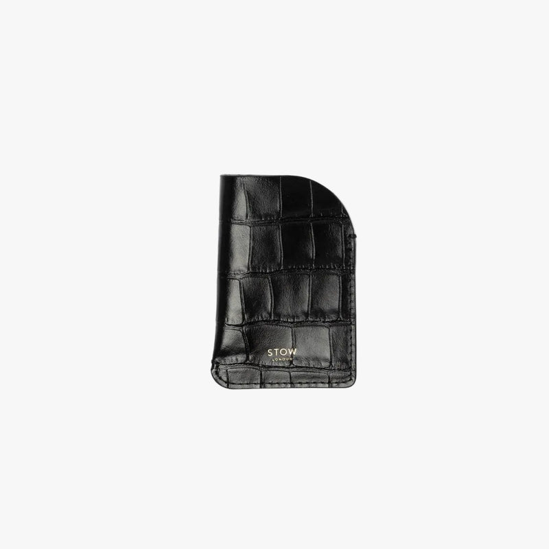 STOW London's Mini Cardholder in Black Embossed Croc leather on a light grey background featuring a small gold embossed logo on the front bottom