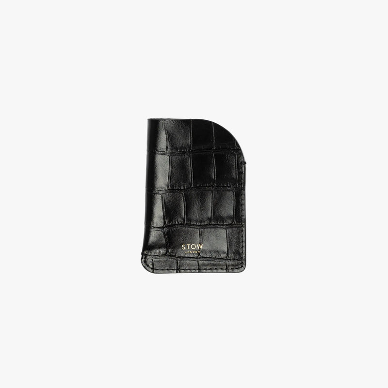 STOW London's Mini Cardholder in Black Embossed Croc leather on a light grey background featuring a small gold embossed logo on the front bottom