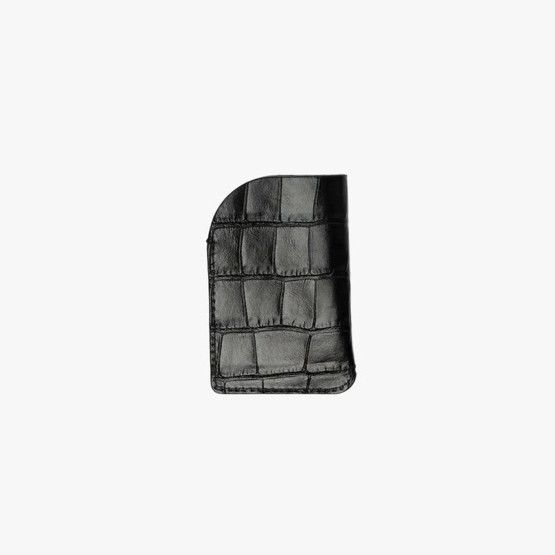 Back panel of STOW London's Mini Cardholder in Black Embossed Croc leather on a light grey background 
