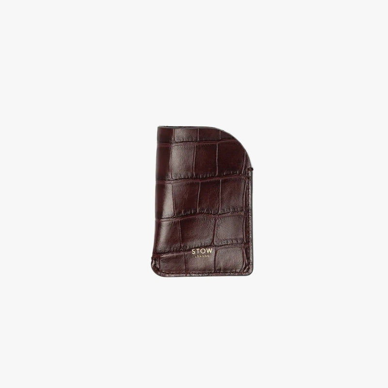 STOW London's Mini Cardholder in Burgundy Embossed Croc leather on a light grey background featuring a small gold embossed logo on the front bottom